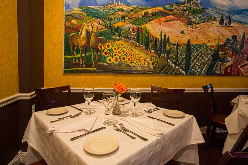 Dining room table with seating for four and view of painting in background